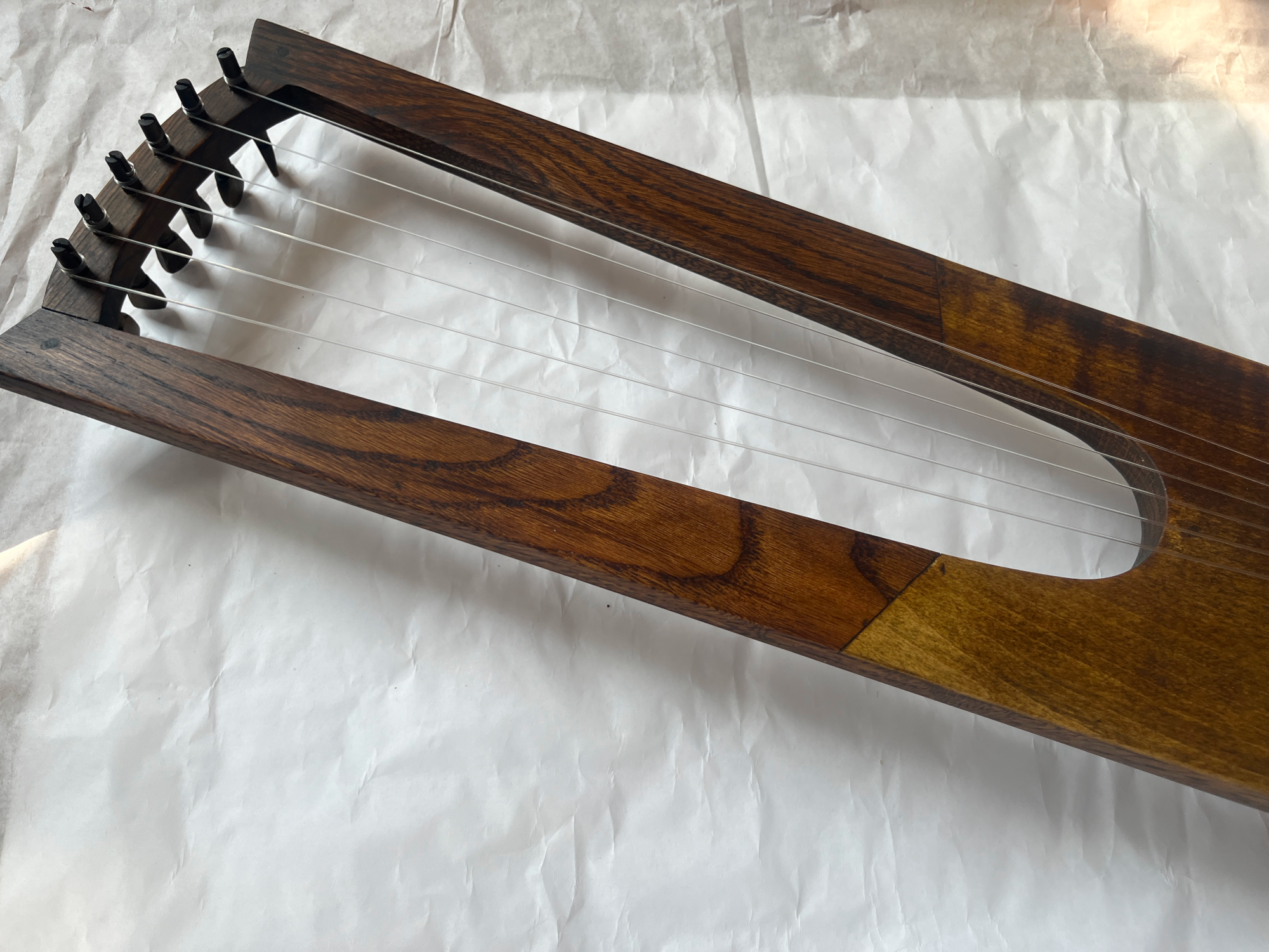front view of oberflacht lyre in oak and maple